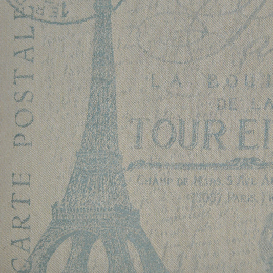 Beige fabric with blue Eiffel Tower silhouette and Paris text motif; vintage travel print for upholstery or crafts.