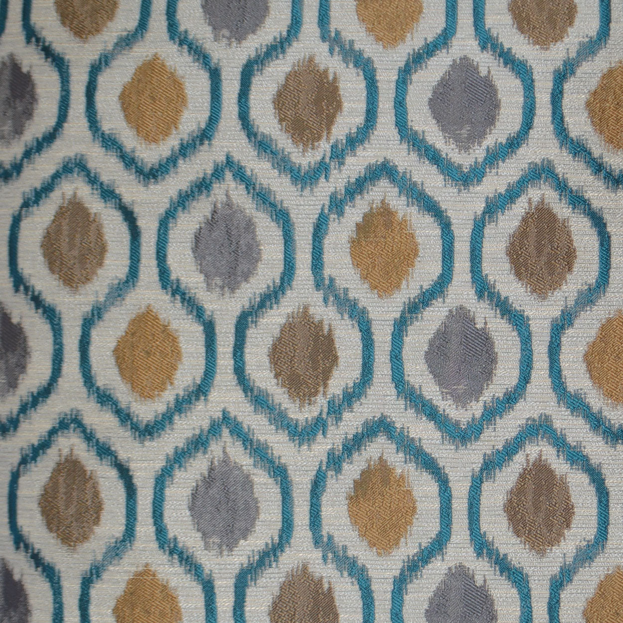 Geometric teal diamond lattice fabric with mustard, taupe, and gray centers on ivory background.