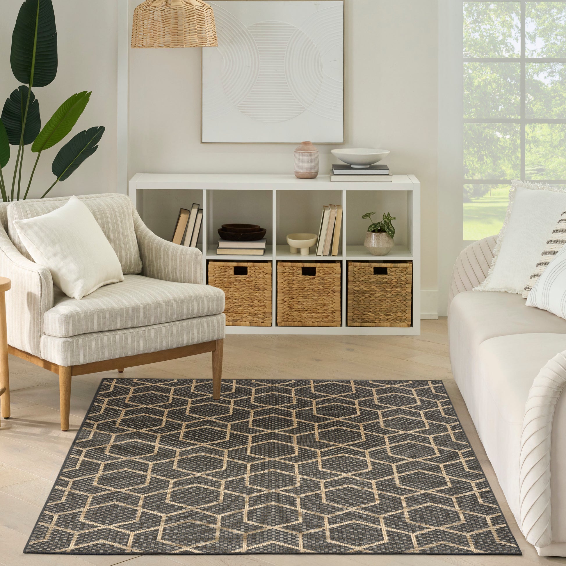 Neutral living room with white cubby storage, woven baskets, beige striped armchair, white sofa, and a gray-beige hex rug.