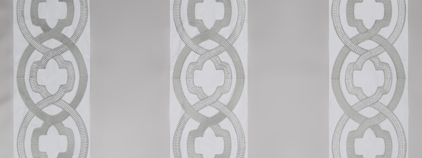 Repeating gray interlocking rings with quatrefoil centers on a light background; wallcovering or textile pattern.