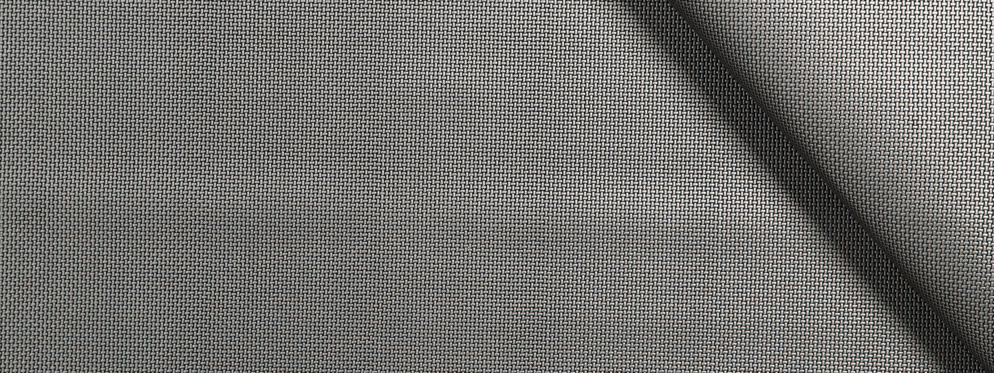 Close-up of gray woven fabric with fine grid texture and a diagonal seam.