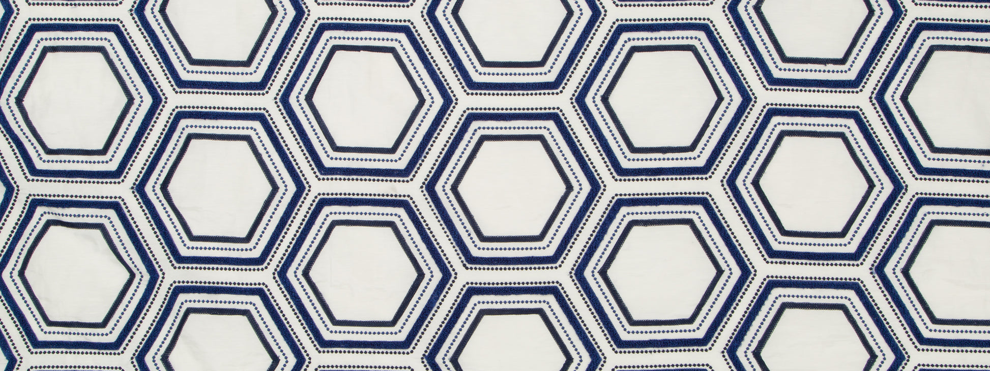 Geometric hexagon lattice in navy and light blue double lines on white background, repeating pattern for wallpaper or fabric.