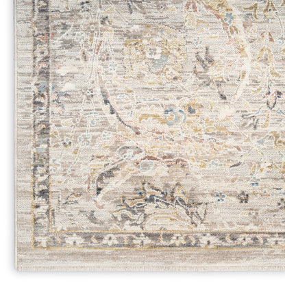Rectangular light cream area rug with pale blue and gold floral damask pattern and decorative border.