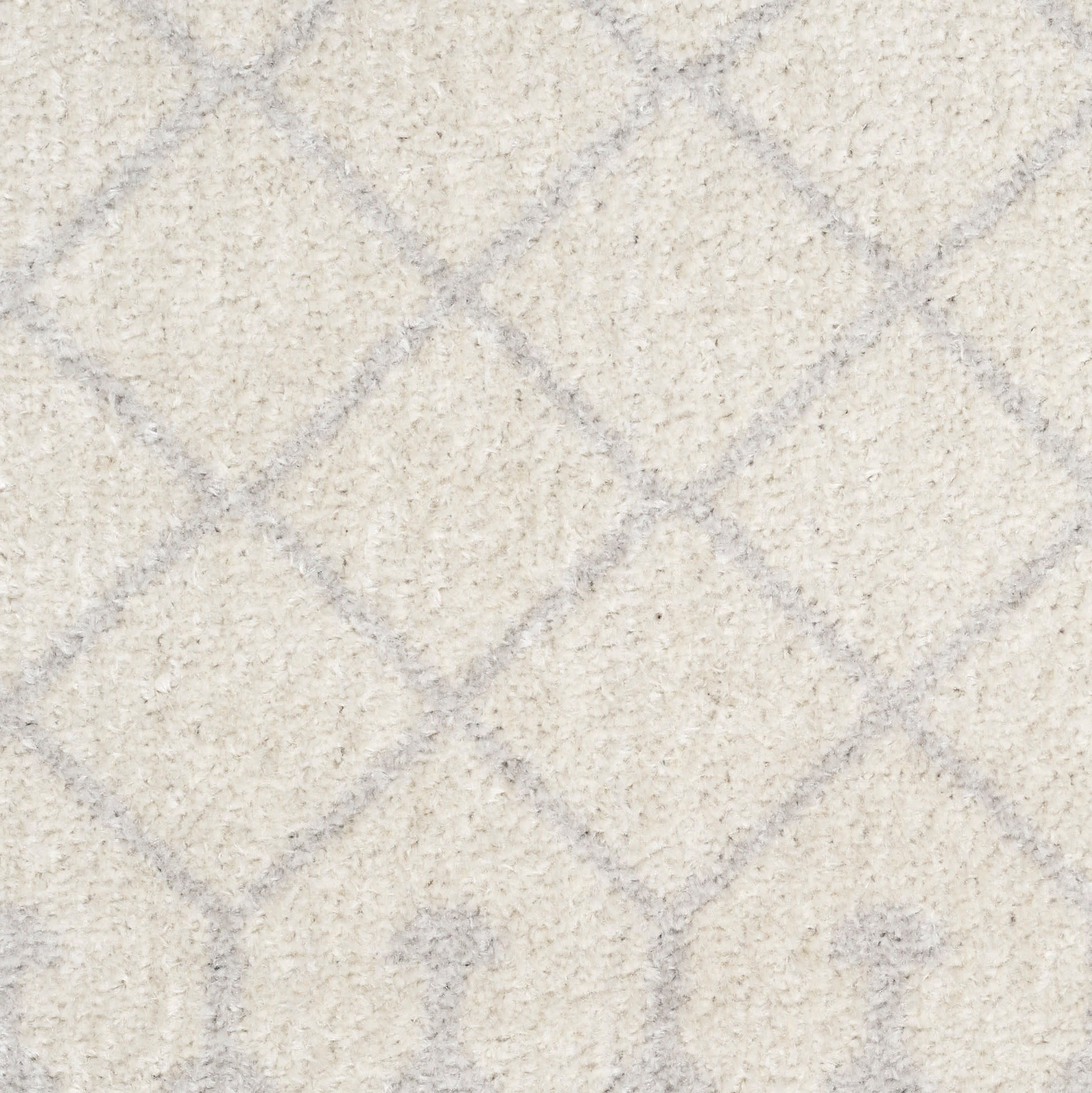 Beige shag rug with subtle gray diamond lattice pattern; soft, plush texture for neutral living spaces.
