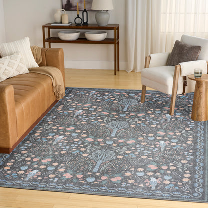 Blue floral-patterned area rug with pink accents in a cozy living room; tan leather sofa and white armchair, curtains.