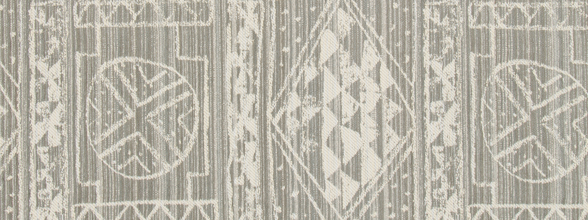 Beige upholstery fabric with cream geometric medallions, diamonds and circles in a boho kilim-inspired pattern.