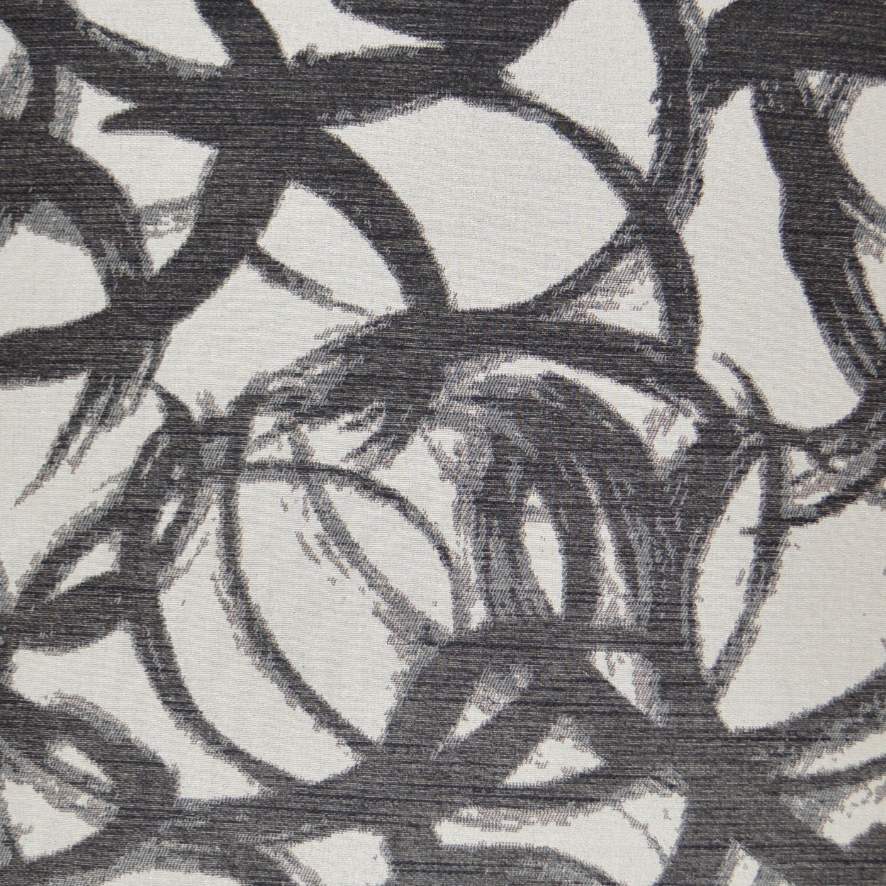 Interlocking circular charcoal loops on pale gray woven fabric, abstract pattern.