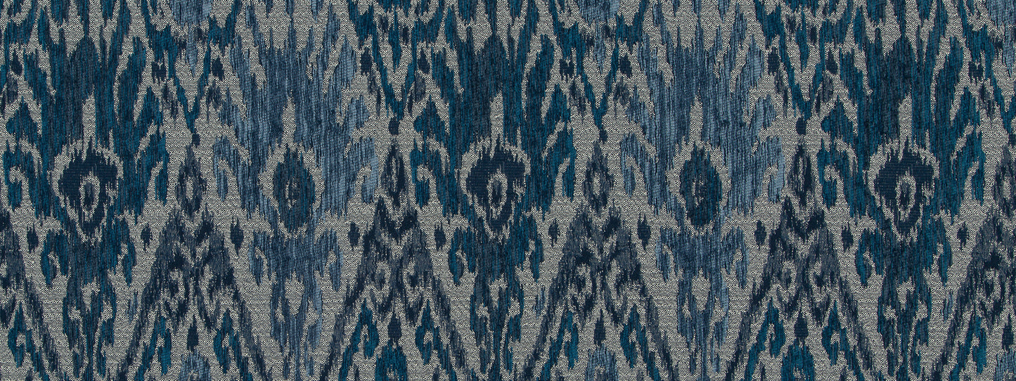 Indigo ikat woven fabric with navy and light-blue diamond motifs, suitable for rug or upholstery.