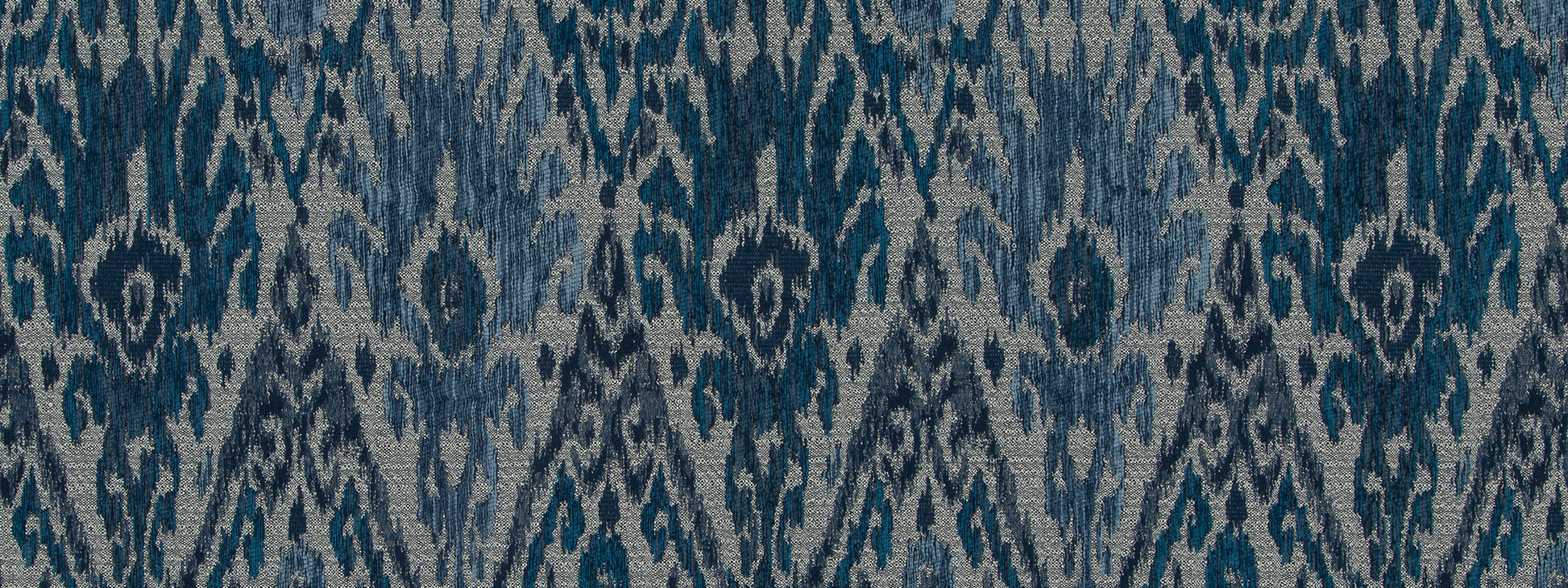 Indigo ikat woven fabric with navy and light-blue diamond motifs, suitable for rug or upholstery.