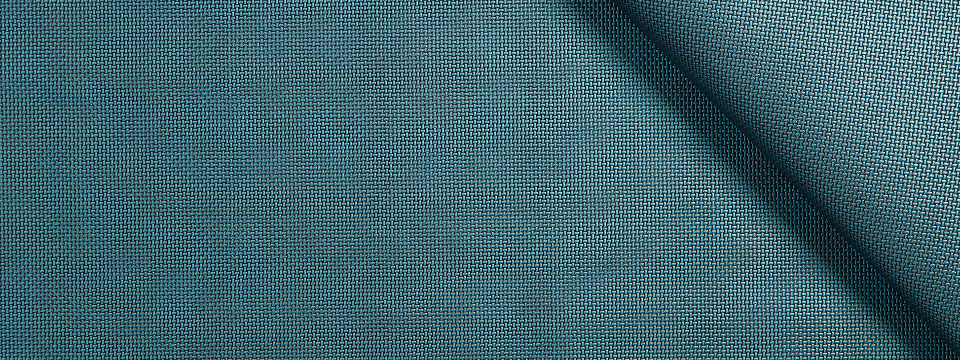 Teal blue woven fabric with fine texture and a diagonal fold; ideal for upholstery, cushions or curtains.