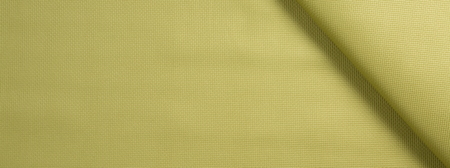 Close-up of light lime-yellow woven fabric with a diagonal fold and soft textured surface.