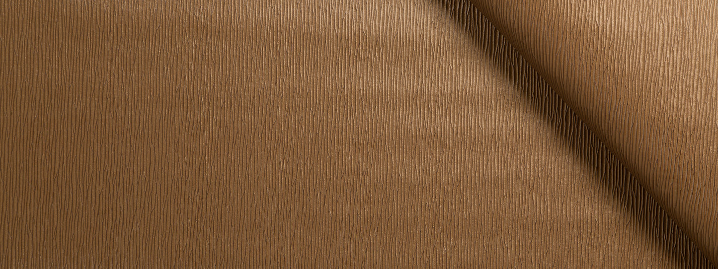 Camel upholstery fabric with a fine grain and a dark diagonal seam.