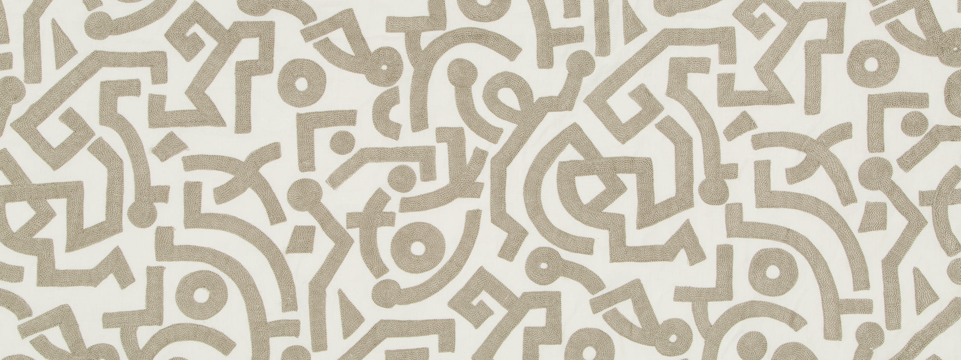 Beige taupe arabesque geometric pattern on cream background; decorative wallpaper or textile motif.