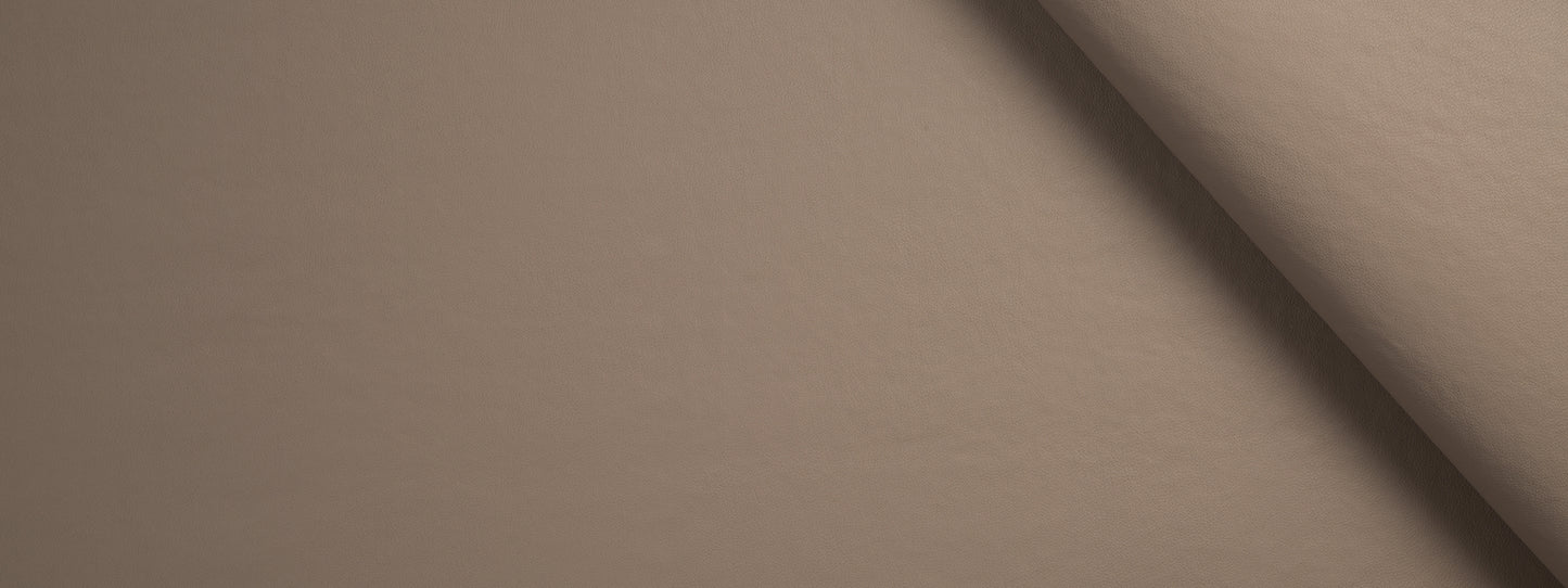 Beige fabric roll with soft texture and curved edge; warm taupe color for upholstery or crafts.