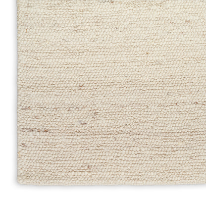 Cream boucle rug with plush loop pile, cotton blend, rectangular & neutral for cozy living room decor.