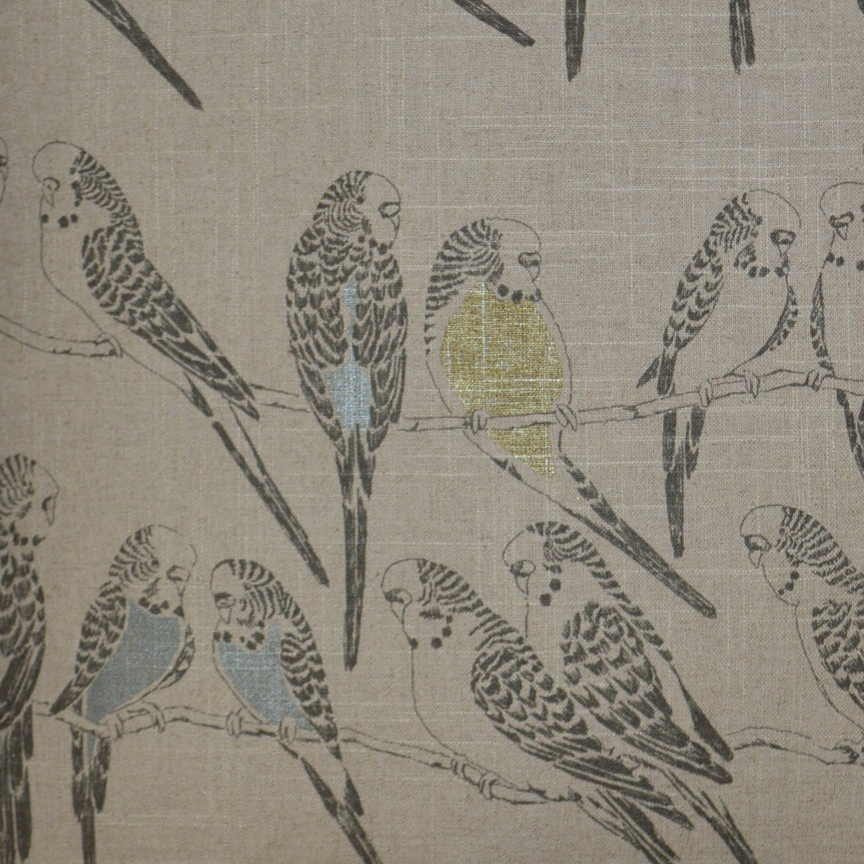 Beige woven fabric pillow, 24" x 24", with a parrot motif of blue and yellow birds perched on branches.