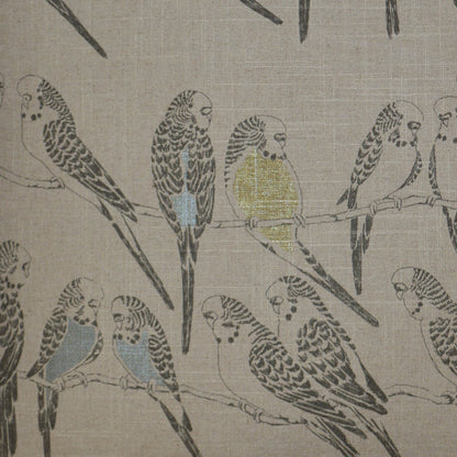 Beige woven fabric pillow, 24" x 24", with a parrot motif of blue and yellow birds perched on branches.