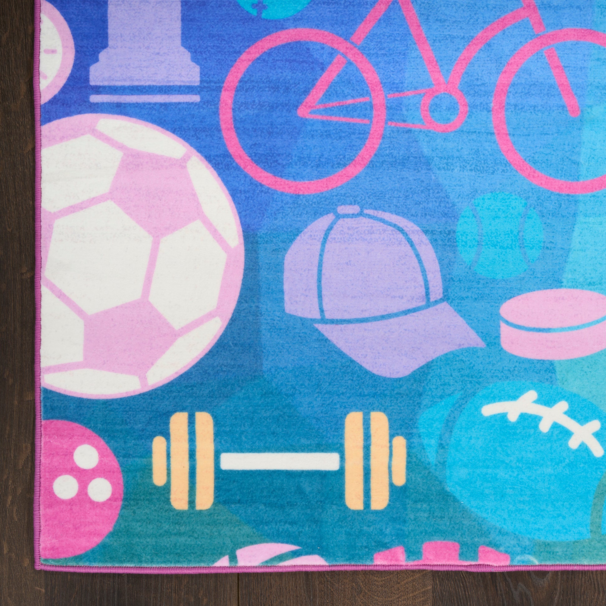 Colorful kids' sports-themed rug with soccer ball, dumbbell, bicycle, hat and football on blue background.