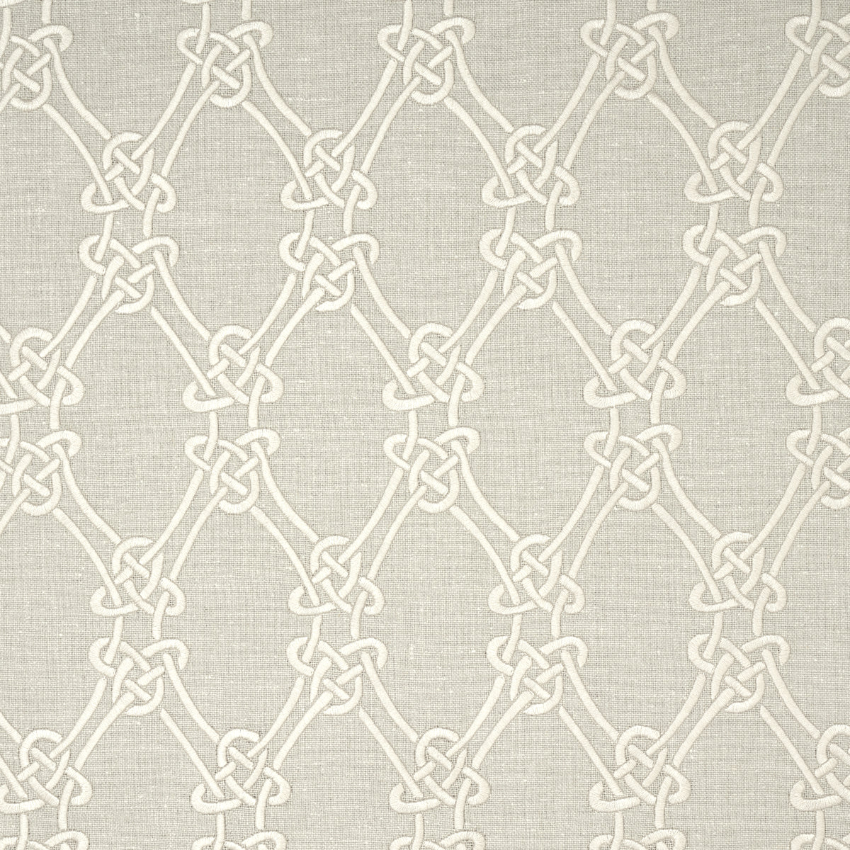 Beige fabric with cream interlocking knot motif forming a repeating lattice pattern.