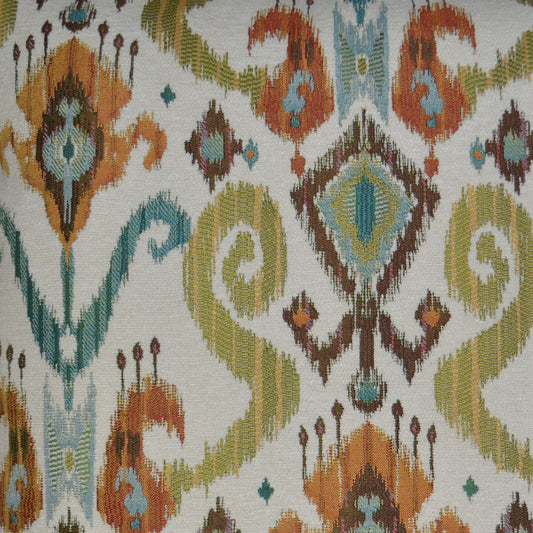 Ikat-inspired woven fabric with turquoise, orange, lime green and brown geometric diamonds on ivory.