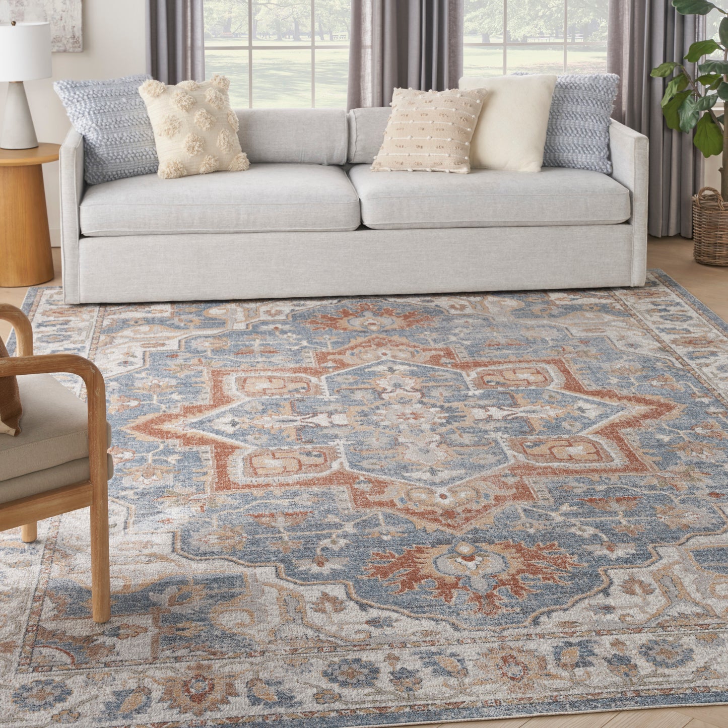 Blue and rust oriental-patterned rug with an intricate design on the floor.