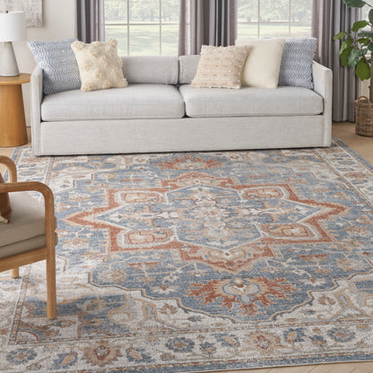 Blue and rust oriental-patterned rug with an intricate design on the floor.