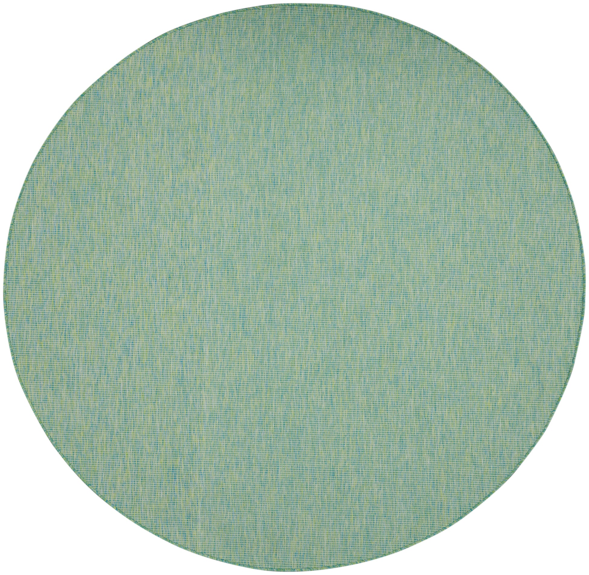 Round teal-green woven rug with pale yellow flecking; casual coastal living room accent.