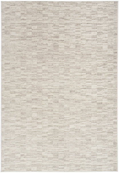 Neutral beige woven area rug with subtle rectangular pattern.
