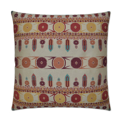 Boho patterned fabric throw pillow with rows of colorful circular motifs in red, orange, yellow and teal on beige.
