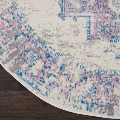 Round cream area rug with pink, blue, and gray distressed pattern; plush textured pile for modern vintage living spaces.