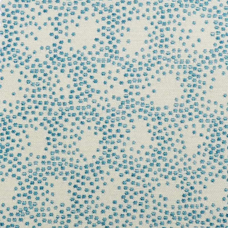 Cream upholstery fabric with turquoise blue speckled dot pattern.
