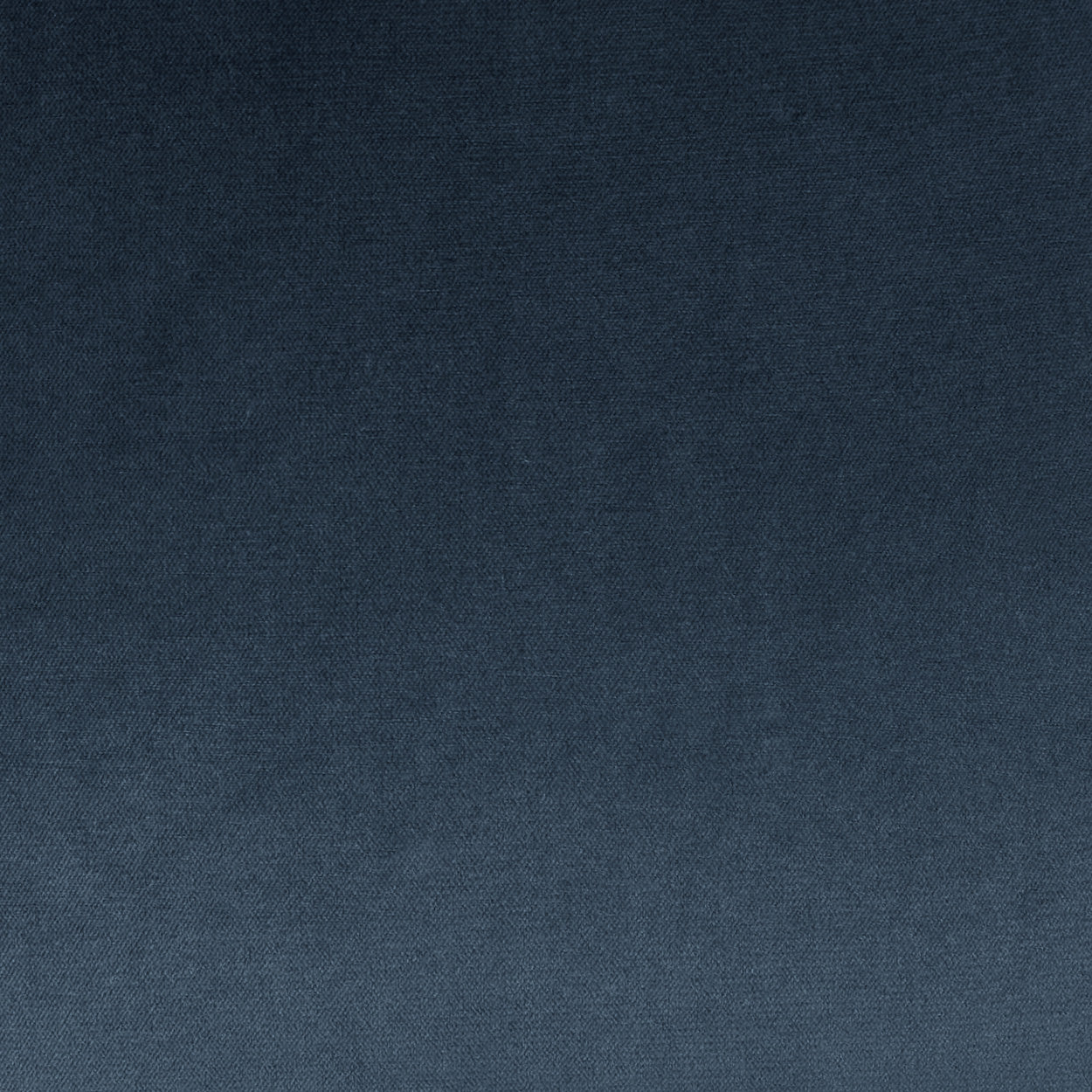 Blue fabric texture with a subtle gradient from dark navy to medium blue; woven textile for upholstery or crafts.
