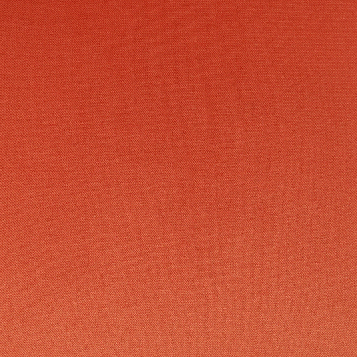 Orange solid pillow fabric close-up with a fine woven texture.