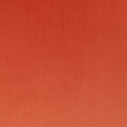 Orange solid pillow fabric close-up with a fine woven texture.