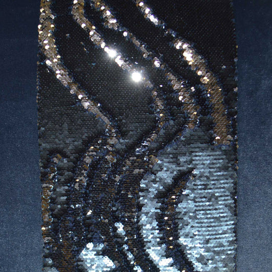 Navy fabric densely covered with silver sequins in sweeping, wavy stripes for a glamorous, metallic look.