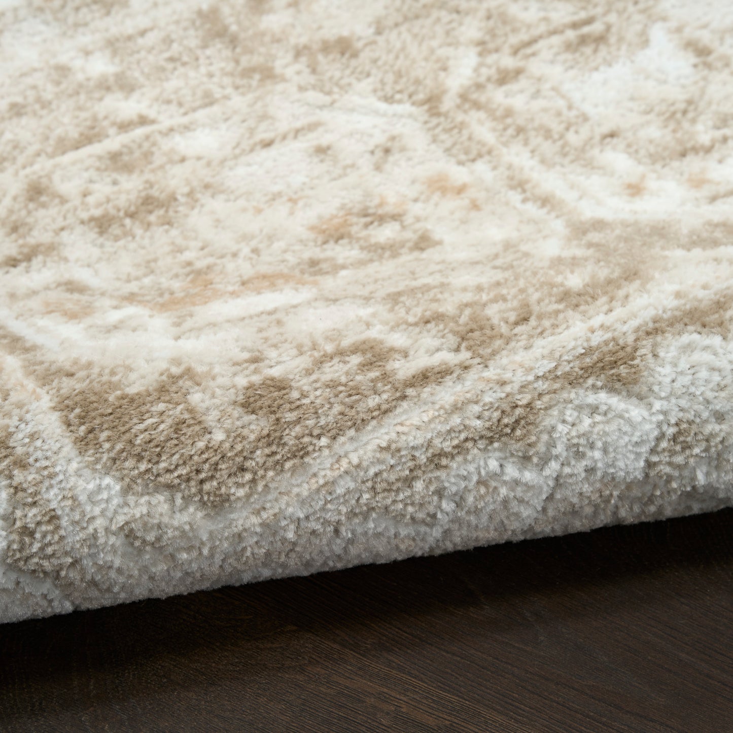 Cream shag rug with a thick plush pile on a dark wood floor.