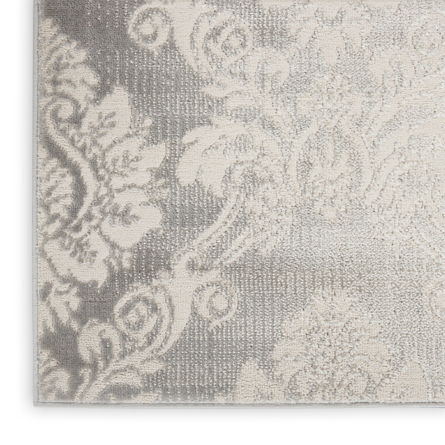 Damask floral textile in grey & ivory with woven texture; elegant upholstery or rug fabric.