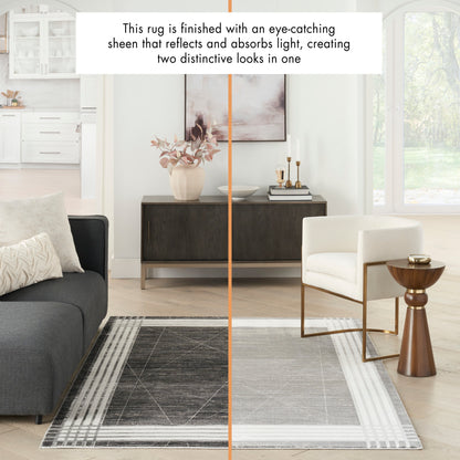Living room with a two-tone rug split dark gray left and light gray right, modern sofa, white chair, wooden side table.