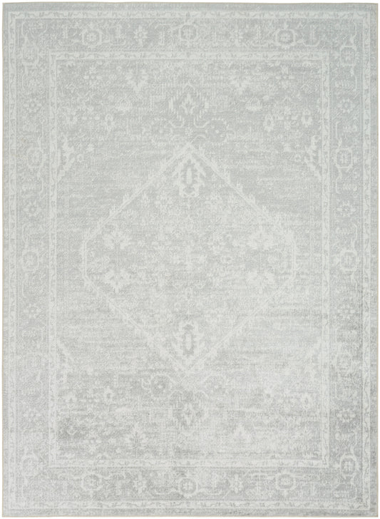 Light gray distressed oriental rug with faded central medallion and floral border, vintage-style decorative floor rug, size 7' x 9'.