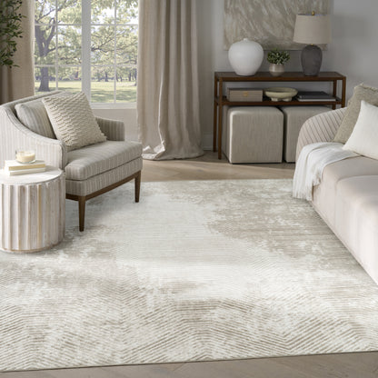 Cream ivory area rug with subtle chevron texture in a neutral living room with beige sofa, armchair, & light wood accents; size 8' x 10'.