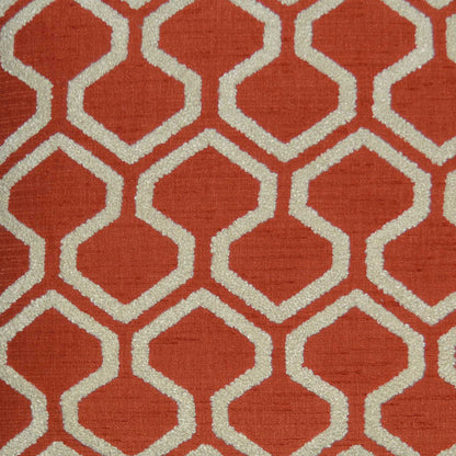 Red-orange pillow with cream interlocking geometric lattice (Moroccan trellis), textured fabric with raw edges, 24" x 24".