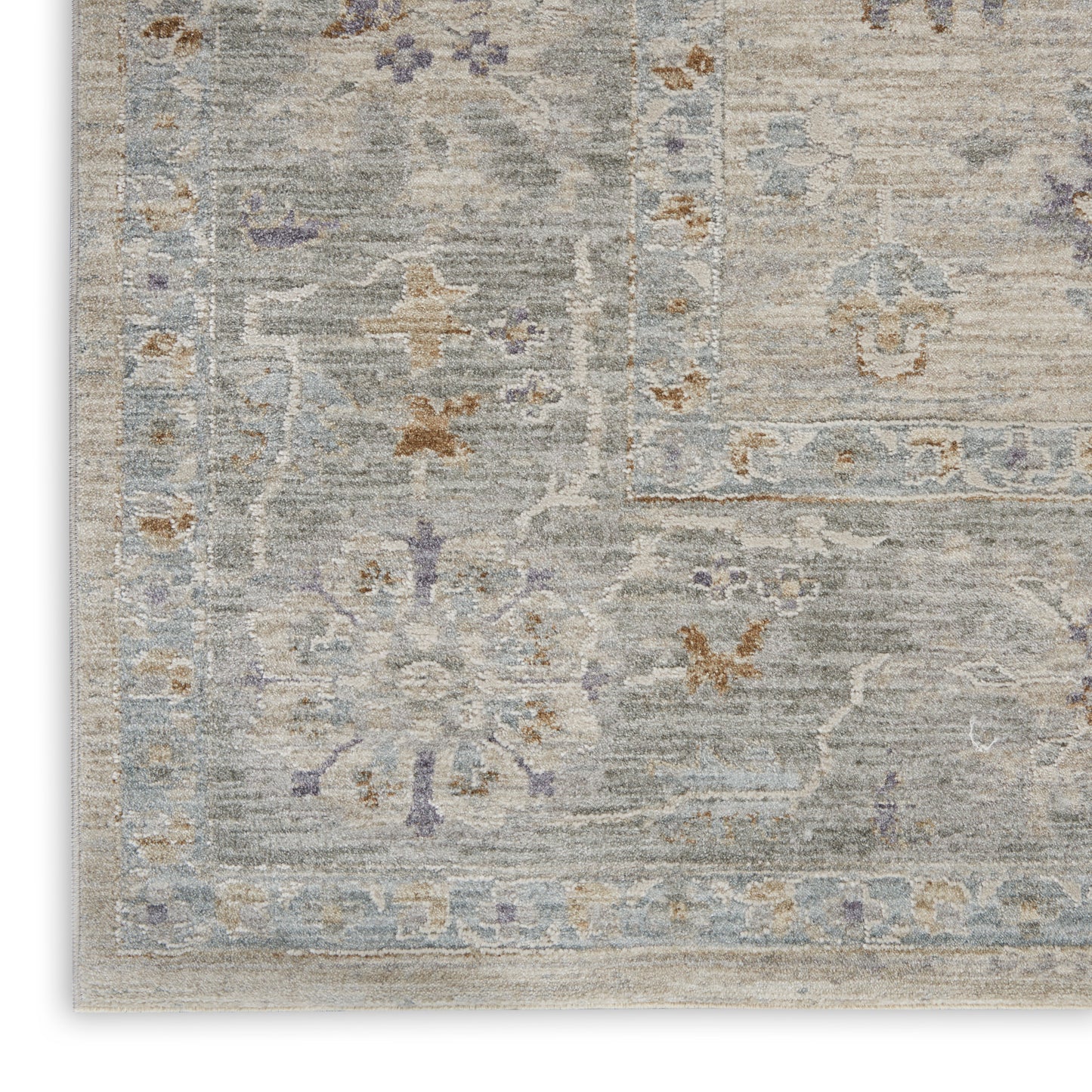 Muted gray-blue oriental-style rug with a faded floral medallion & ornate border, distressed vintage look.