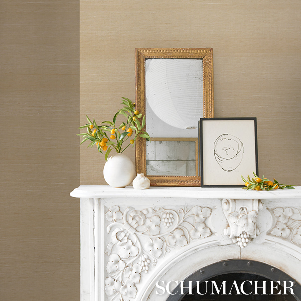 White carved mantel with floral relief, gold ornate frame with mirror, black-framed sketch, white vase with orange berries.