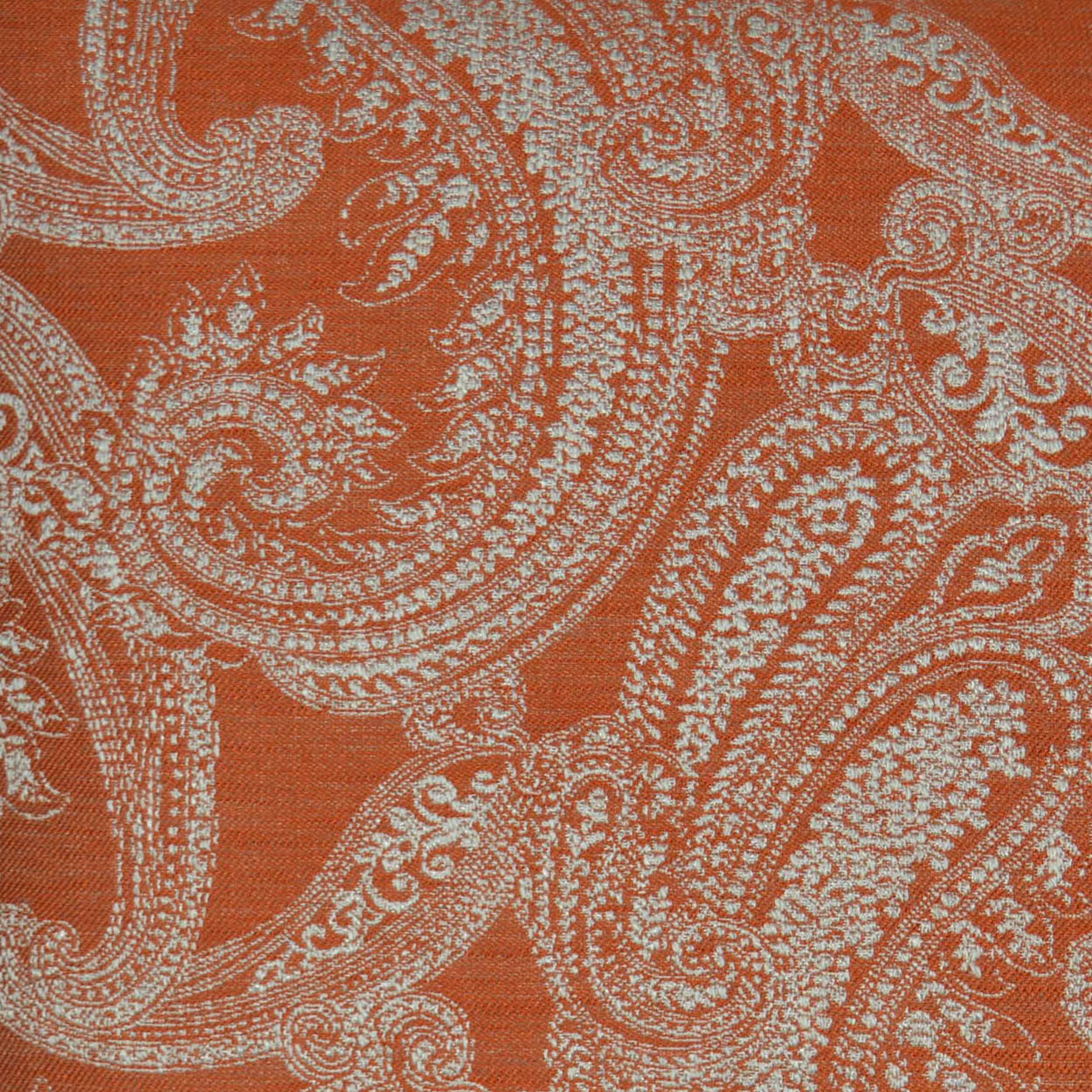 Orange traditional decorative pillow with a white paisley damask jacquard pattern.