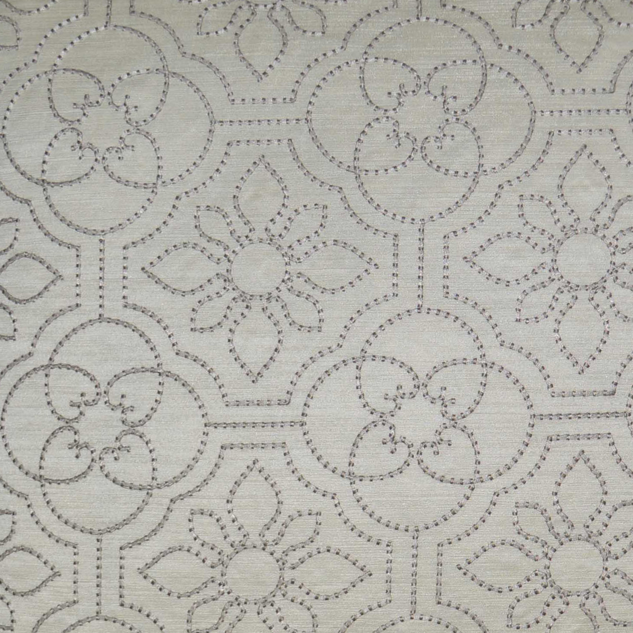 Cream fabric with embroidered geometric floral pattern; circular medallions, dotted lines, lace-like damask motif.