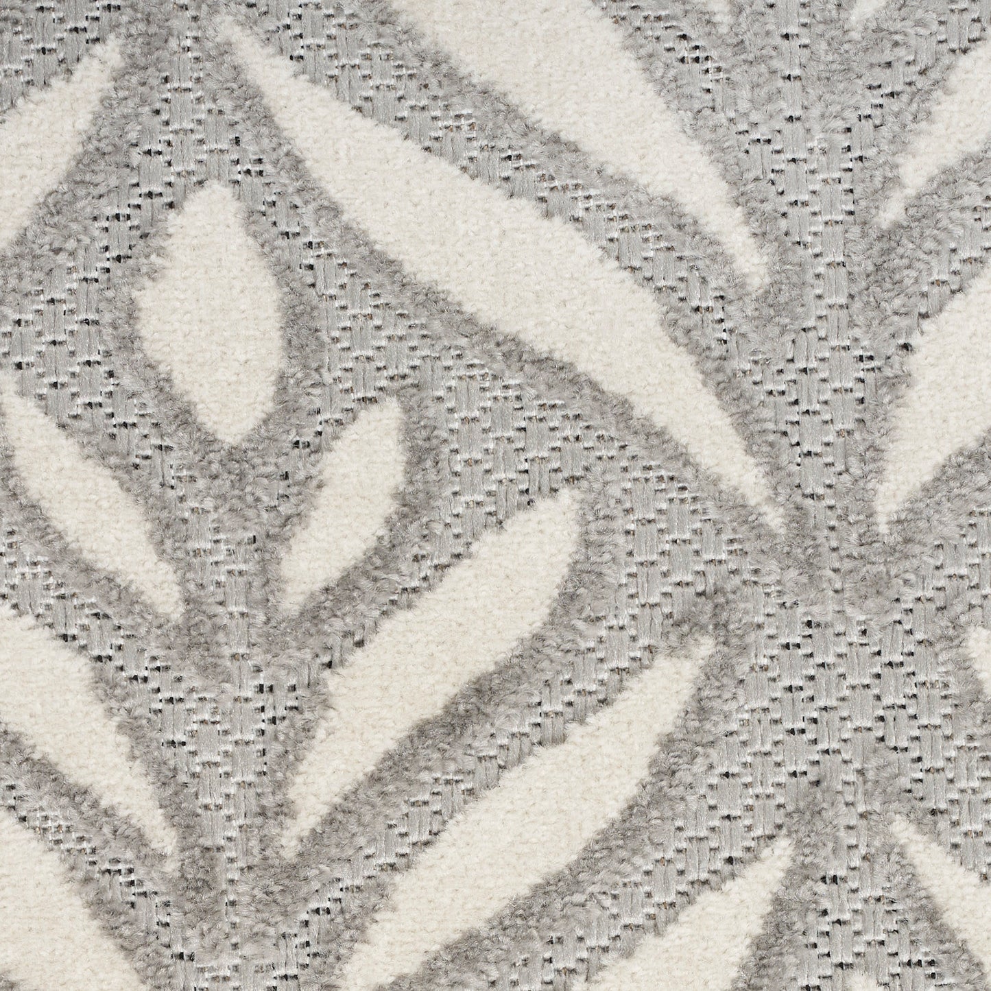 Ivory & gray plush rug with an abstract leaf pattern and textured pile for living room decor.