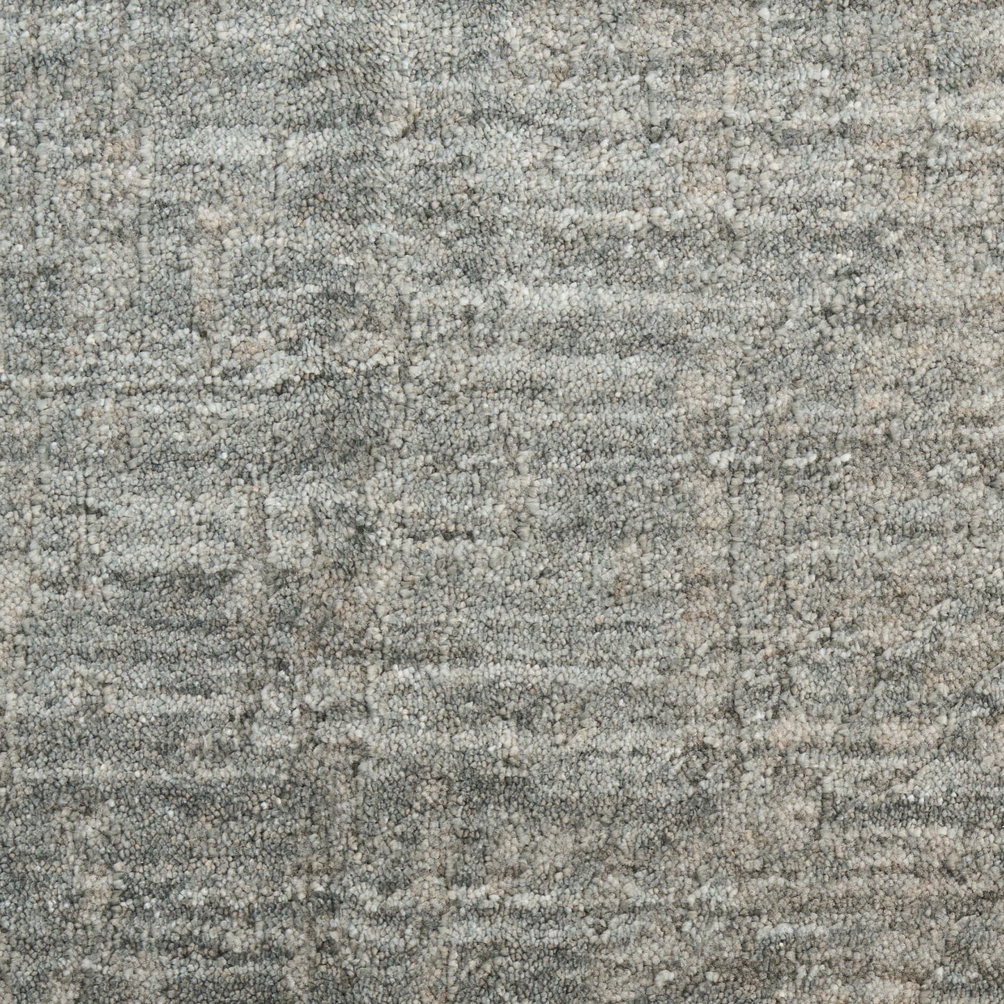Gray-blue textured rug with a distressed speckled pattern and soft woven pile.