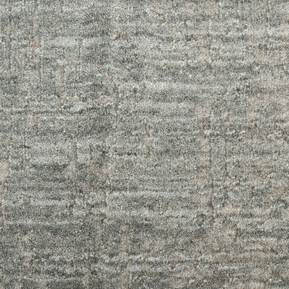 Gray-blue textured rug with a distressed speckled pattern and soft woven pile.