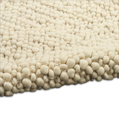 Cream boucle rug with dense ball tufts, plush shag texture for living room decor.