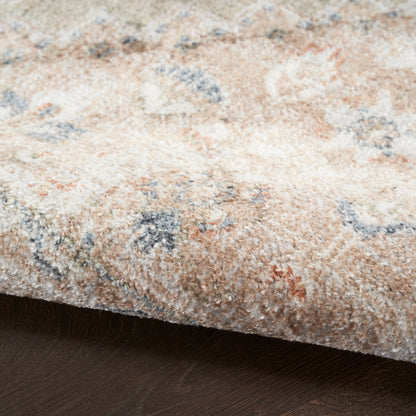 Soft plush beige area rug with blue, cream and peach accents in an abstract floral pattern.